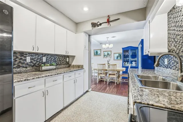 a spacious bedroom with a bed and a wooden floor