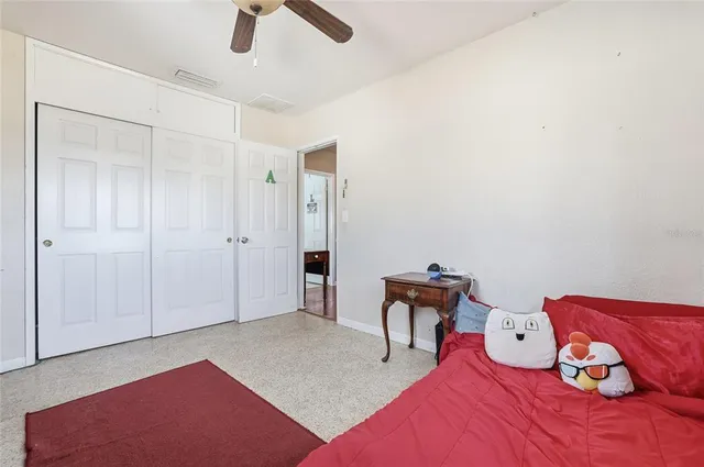 a bedroom with a bed and a painting on the wall