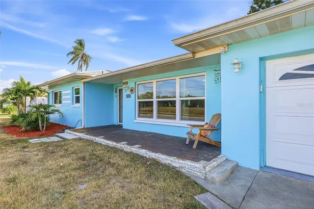 a front view of house with yard and trees around