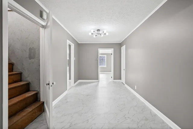 a kitchen with granite countertop white cabinets white stainless steel appliances with a sink and dishwasher