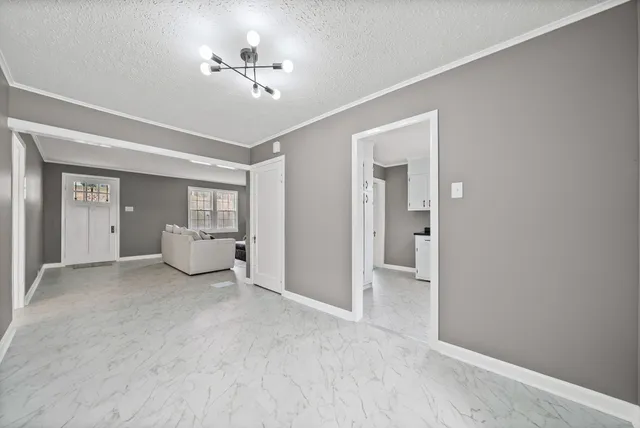 a kitchen with granite countertop a sink cabinets and window