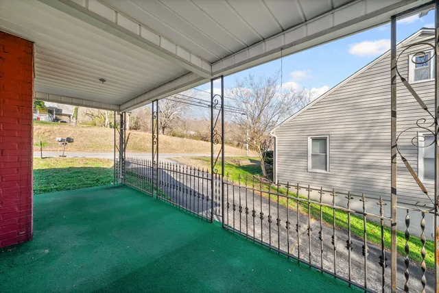 a view of a field with large trees