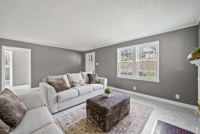 a view of a hallway with wooden floor and entryway