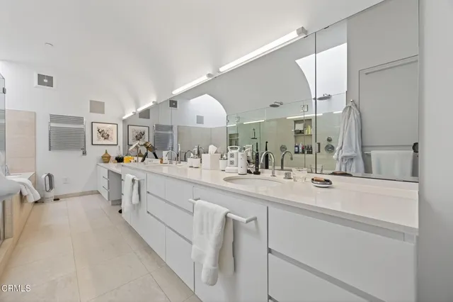 a bedroom with furniture and book shelf