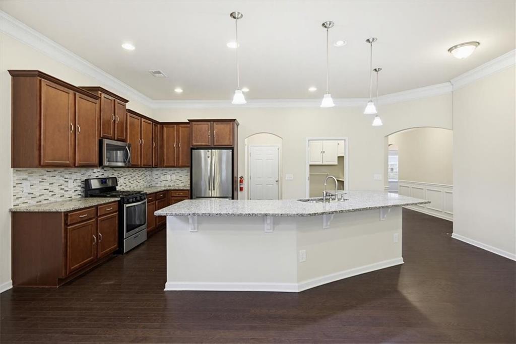 314 Boulder Run Hiram, GA 30141 - Photo 6 of 31 a large kitchen with granite countertop a large counter top a sink stainless steel appliances and cabinets