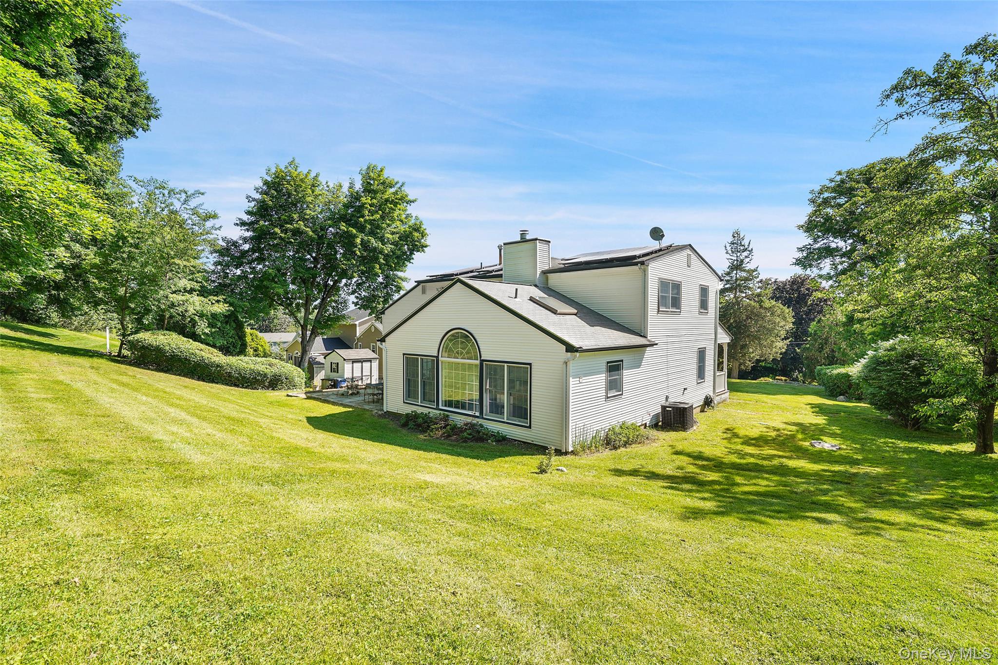 623 Cardinal Road Cortlandt Manor, NY 10567 - Photo 33 of 40 a front view of a house with a yard table and chairs