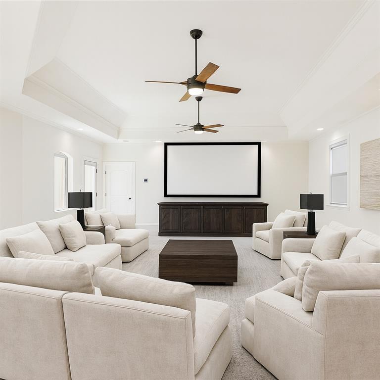 2203 Court Del Rey Round Rock, TX 78681 - Photo 25 of 35 Carpeted home theater room featuring a raised ceiling, ornamental molding, ceiling fan, and recessed lighting