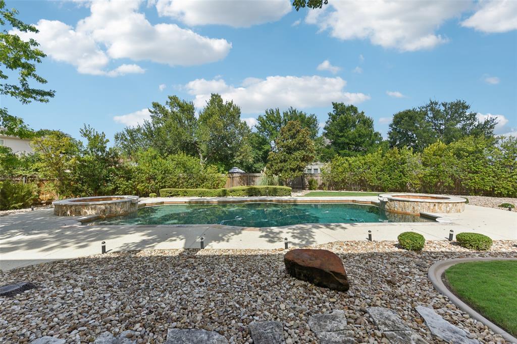 2203 Court Del Rey Round Rock, TX 78681 - Photo 33 of 35 View of pool featuring a pool with connected hot tub, a fenced backyard, and a patio area