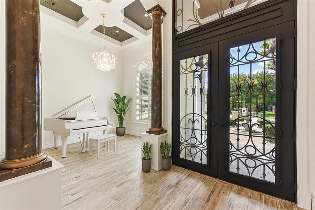 2203 Court Del Rey Round Rock, TX 78681 - Photo 4 of 35 Foyer with ornate columns, coffered ceiling, french doors, light wood-style flooring, and a chandelier