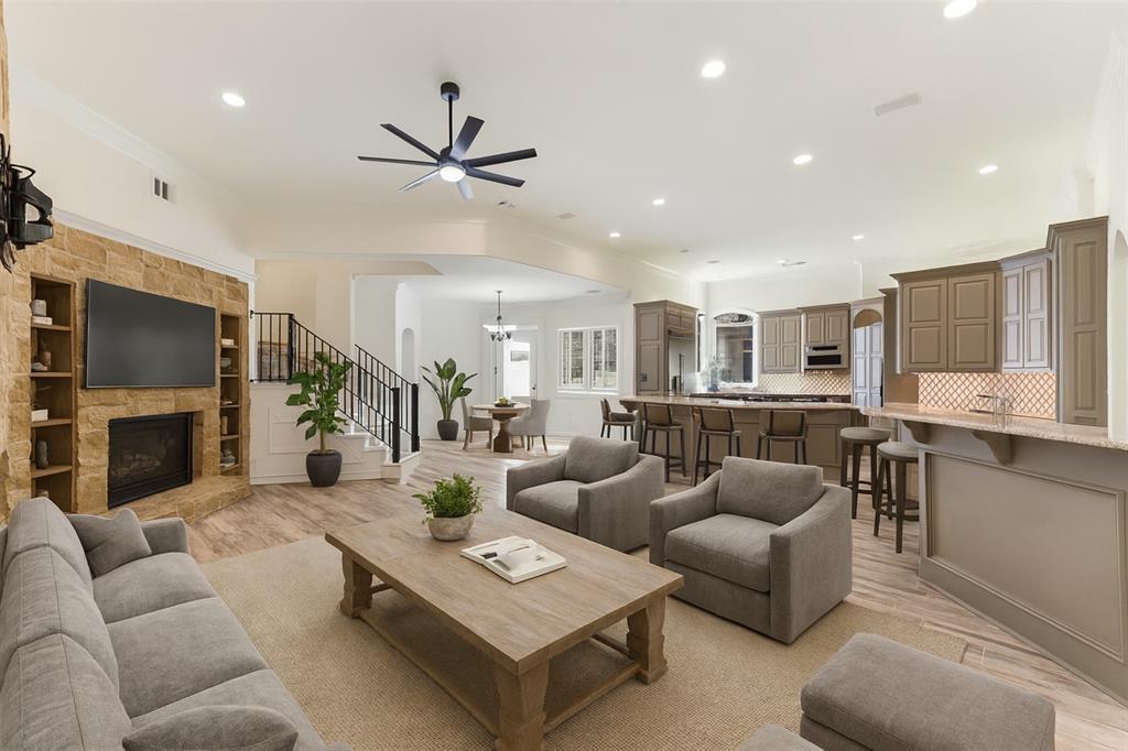 2203 Court Del Rey Round Rock, TX 78681 - Photo 6 of 35 Living area with light wood-style floors, recessed lighting, a ceiling fan, a fireplace, and stairway