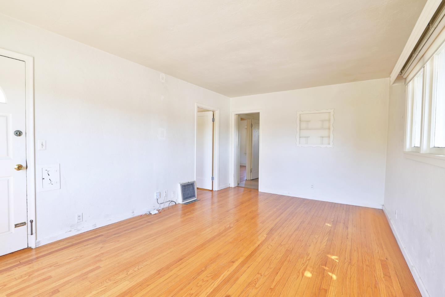 494 Lewis Avenue San Leandro, CA 94577 - Photo 7 of 19 a view of an empty room with wooden floor and a window
