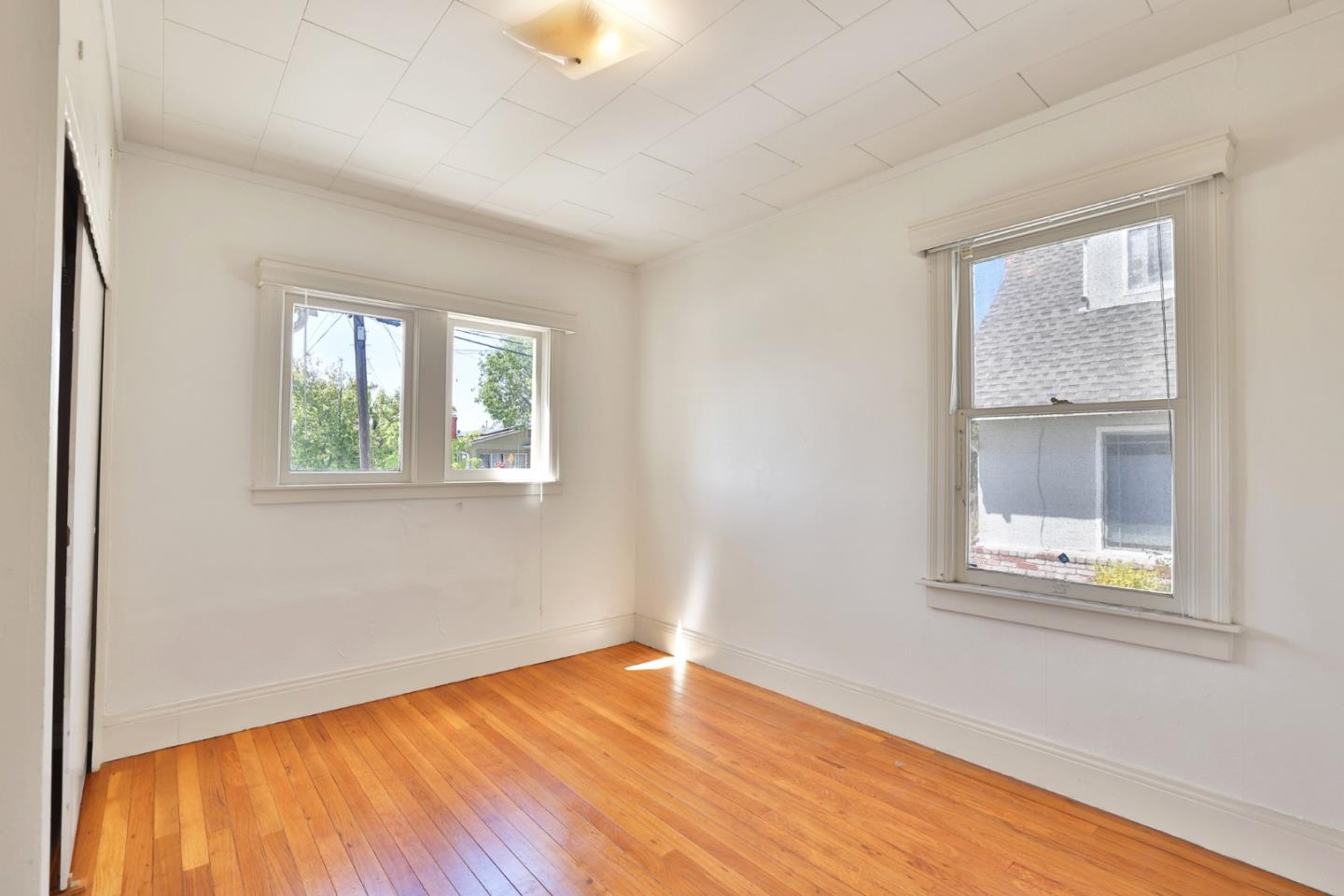 494 Lewis Avenue San Leandro, CA 94577 - Photo 8 of 19 a view of an empty room with wooden floor and a window