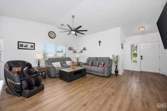 a living room with furniture and wooden floor