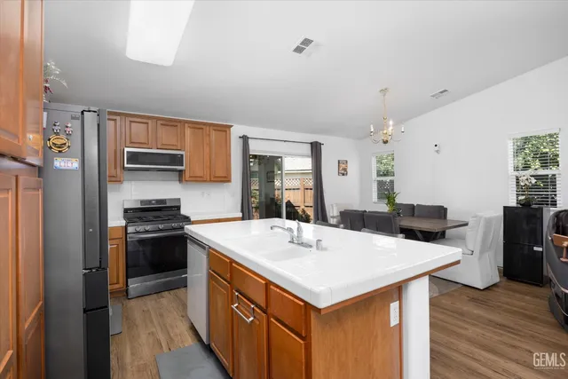 a view of kitchen with sink refrigerator and microwave