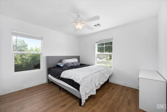 a bed sitting in a bedroom next to a window