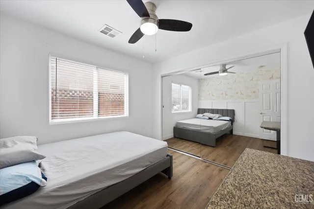 a bedroom with a bed and a large window