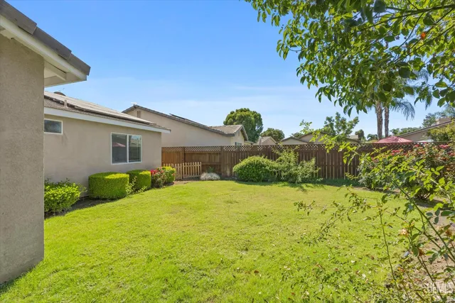 a yellow house with trees in front of it