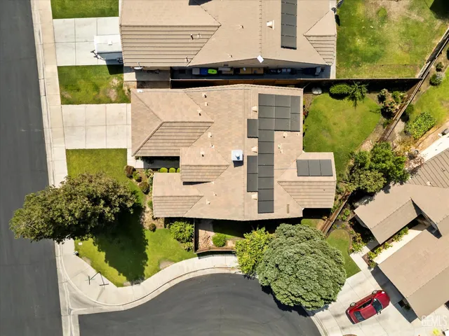 an aerial view of a house with a yard