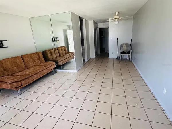 a living room with a couch and a rug