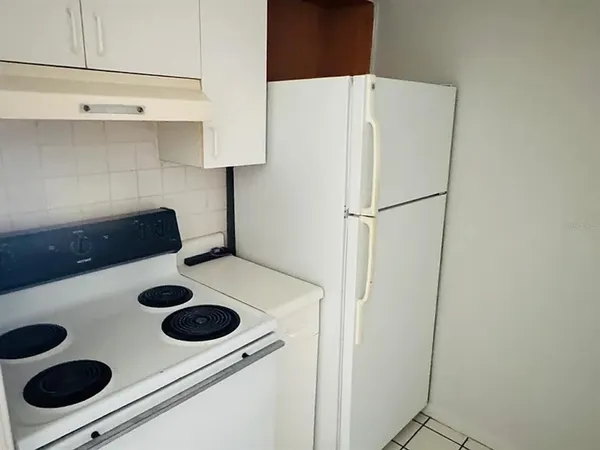 a white refrigerator freezer sitting inside of a kitchen