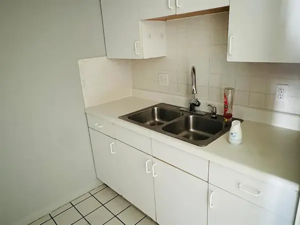 a kitchen with a sink and cabinets