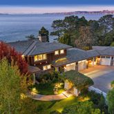 an aerial view of a house with a yard wooden table and chairs