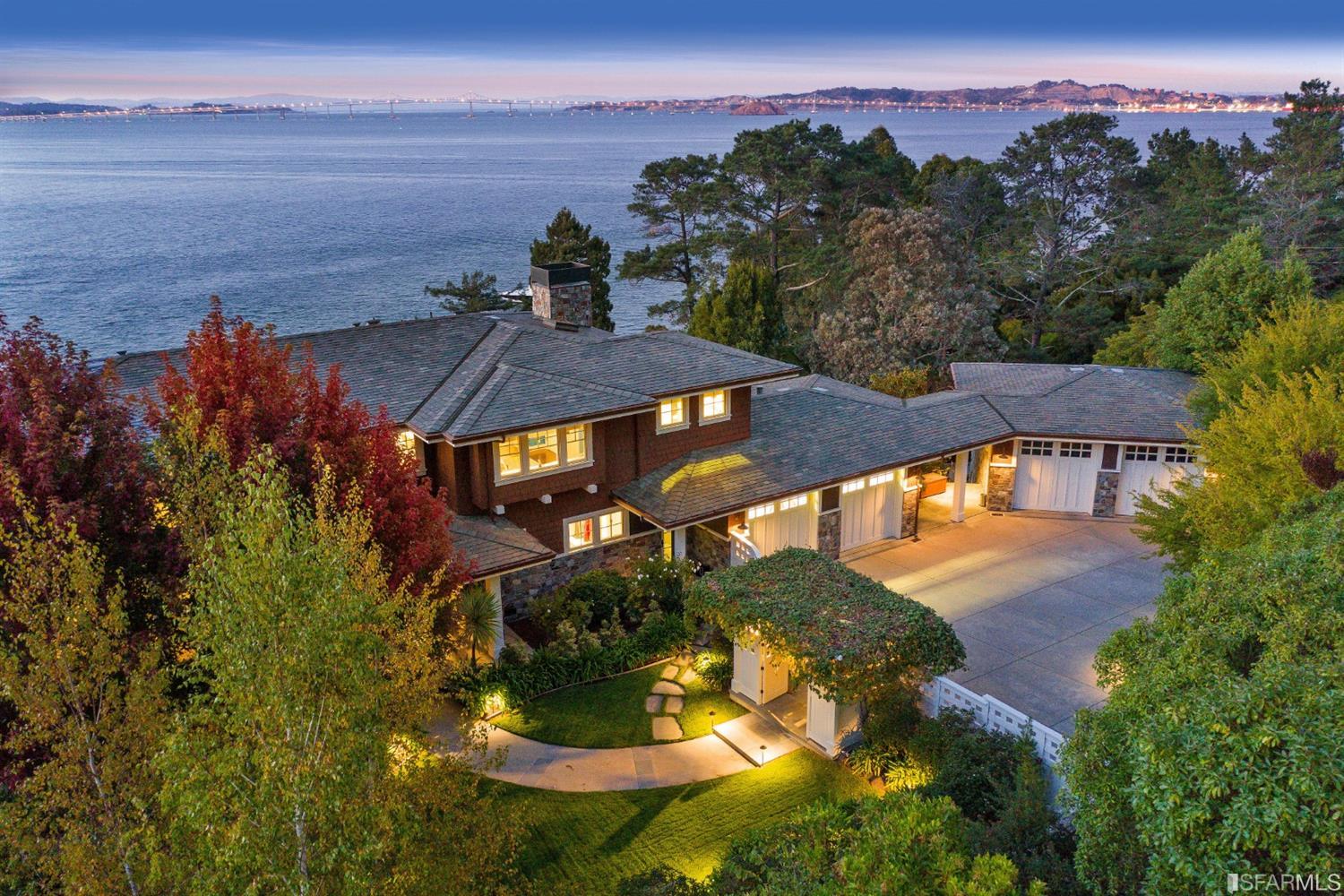 an aerial view of a house with a yard wooden table and chairs