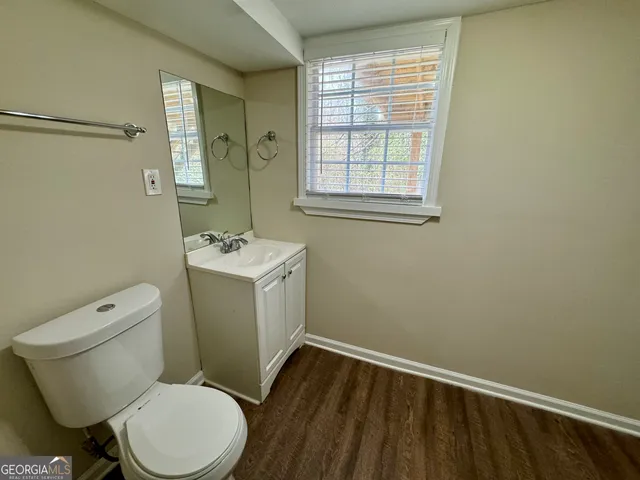 a white toilet sitting next to a bathroom sink