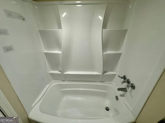 a bathroom with a white bath tub