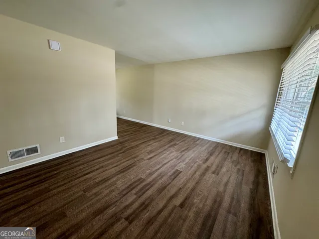 a view of wooden floor in an empty room
