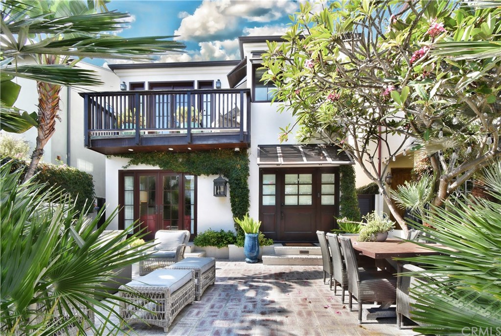 a front view of a house with outdoor seating