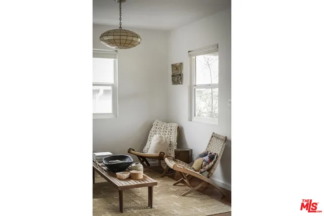 a very nice looking living room with furniture and a chandelier