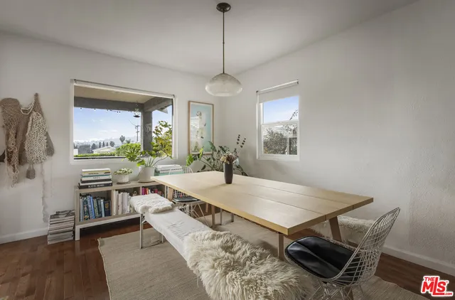 a living room with furniture a chandelier and a dining room