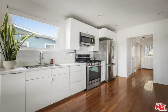 a kitchen with a stove a sink and a microwave