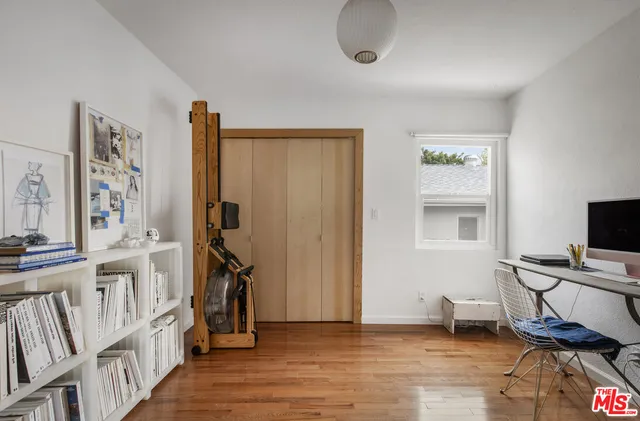 a view of a workspace with furniture and wooden floor