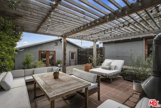 a living room with wooden floor and furniture
