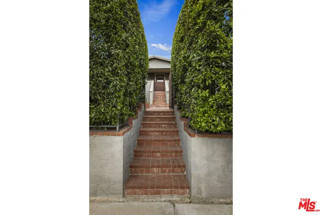 a hallway with stairs and a yard