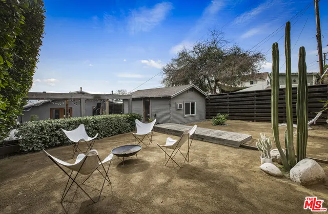 a view of a patio with furniture and a fire pit