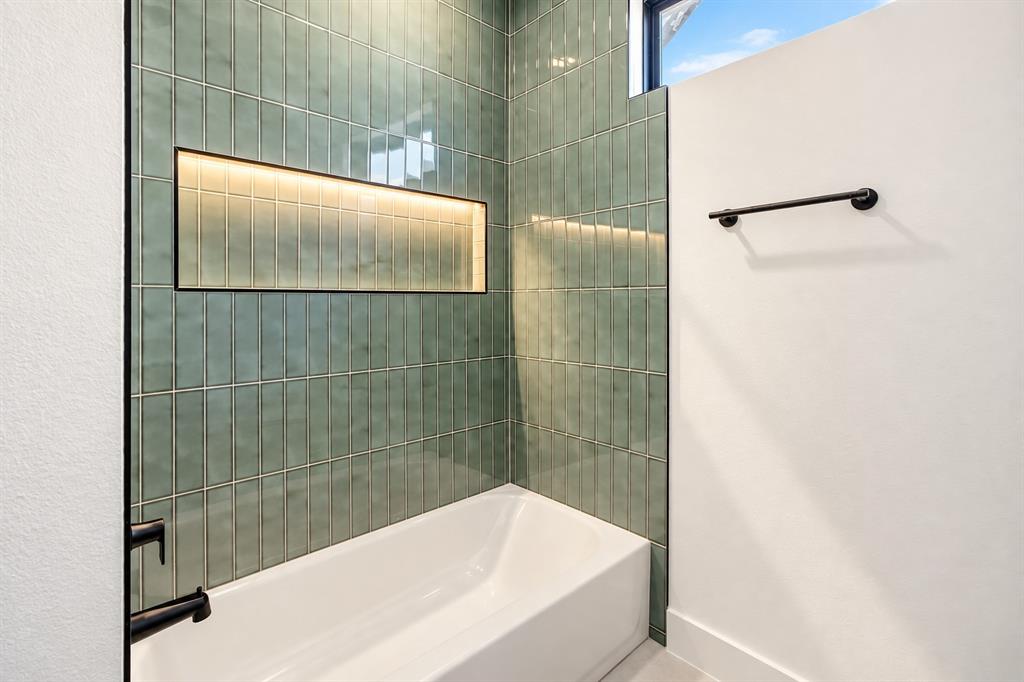 1640 West Wintergreen Road Lancaster, TX 75134 - Photo 32 of 37 Second Bathtub with contemporary vertical green tile surround, illuminated shower niche, and matte black fixtures