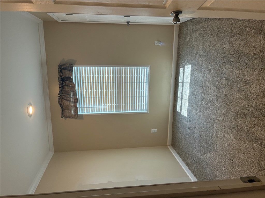 Soft carpeting pairs with classic crown molding in this comfortable bedroom space.