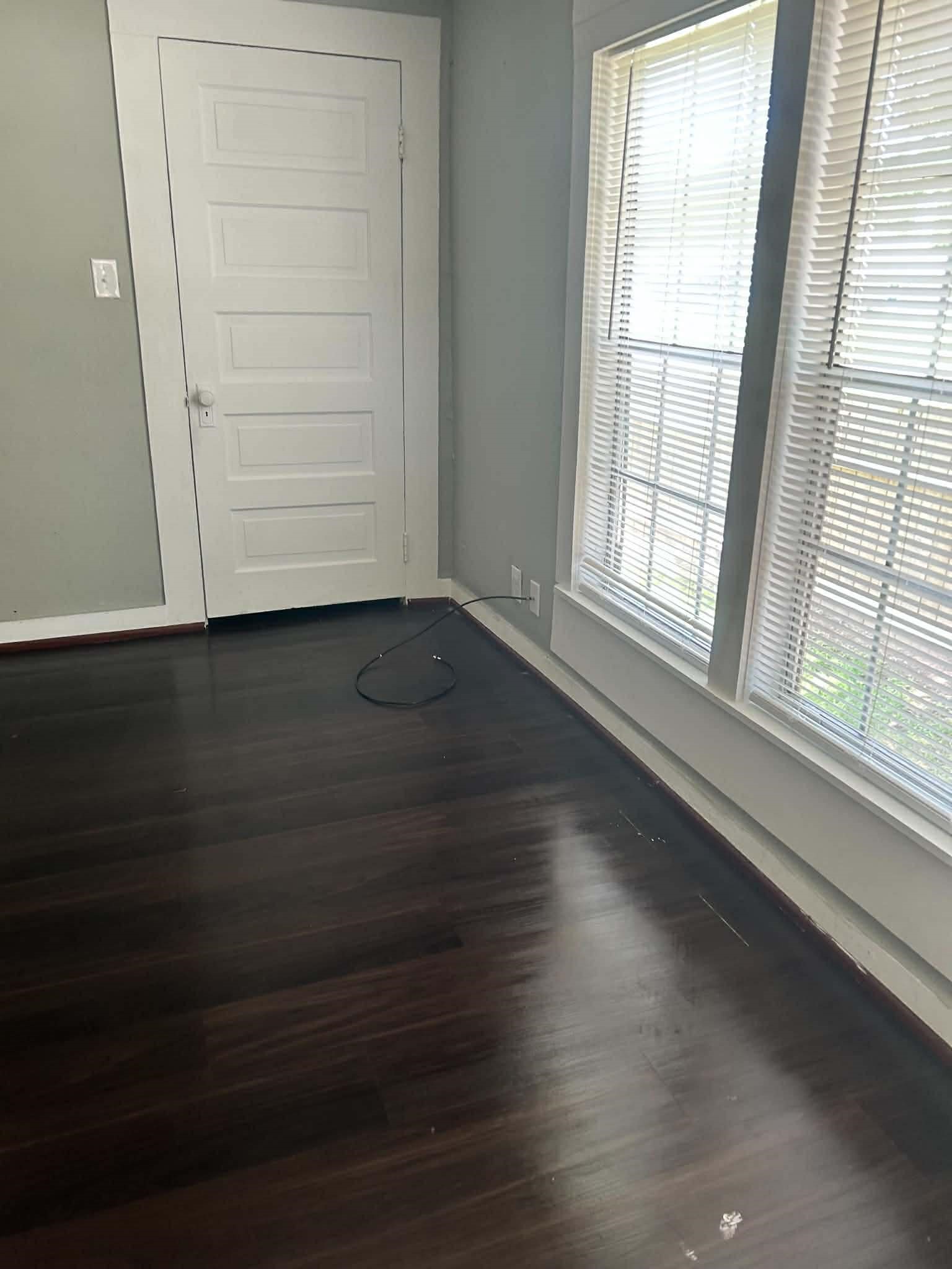11 Smith Street Shepherd, TX 77371 - Photo 26 of 31 an empty room with wooden floor cabinet and windows