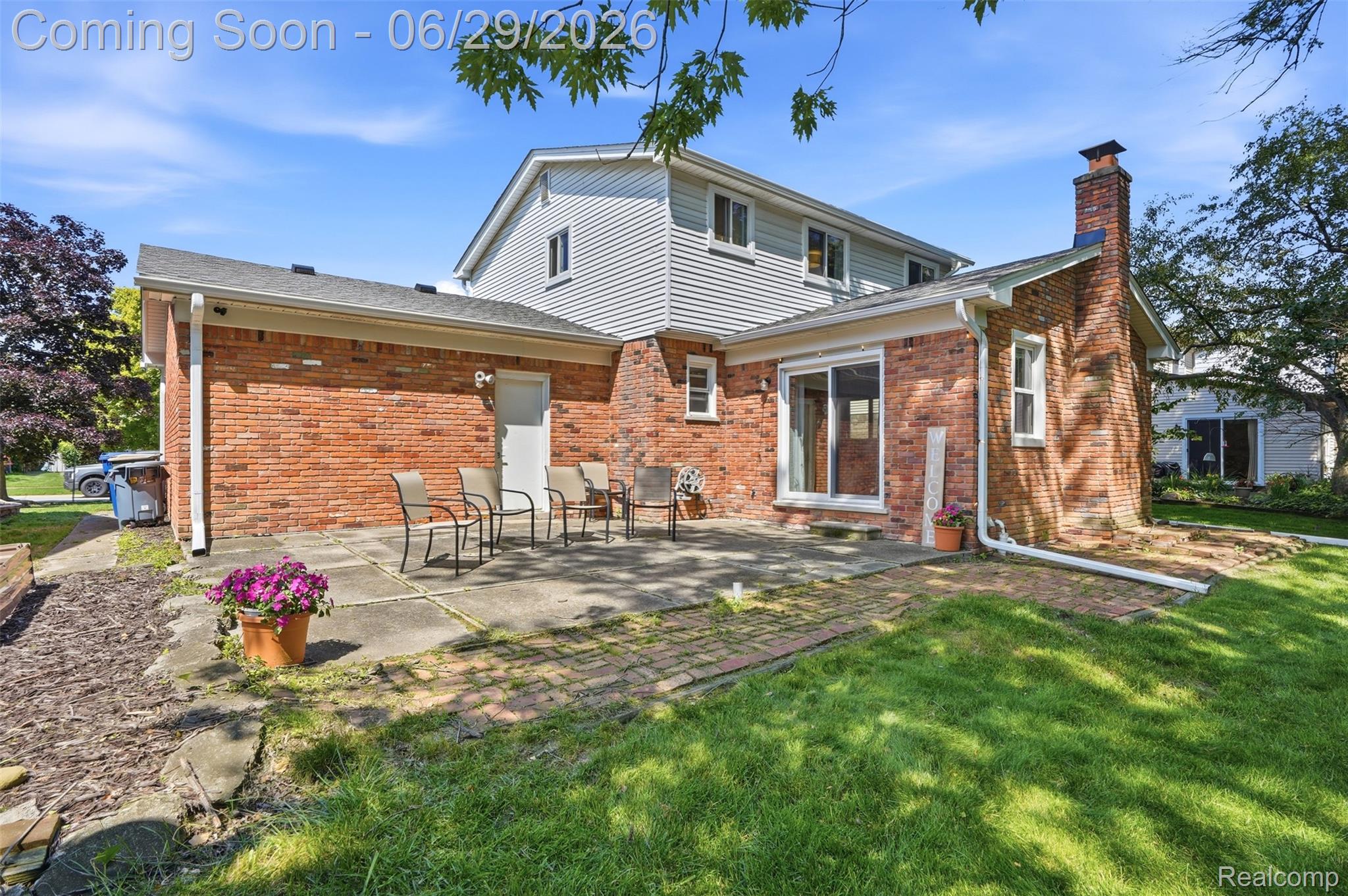 45179 Rudgate Road Canton, MI 48188 - Photo 29 of 48 Brick exterior with siding accents, featuring a patio area with a mix of concrete and brick pavers