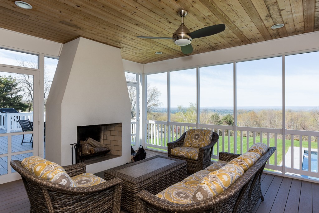 821 Ridge Road Wilbraham, MA 01095 - Photo 21 of 30 a living room with furniture a fireplace and a floor to ceiling window