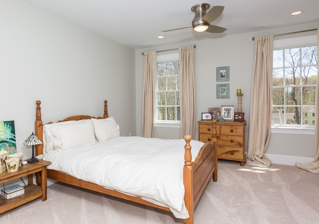 821 Ridge Road Wilbraham, MA 01095 - Photo 26 of 30 a bedroom with a bed chandelier and a window