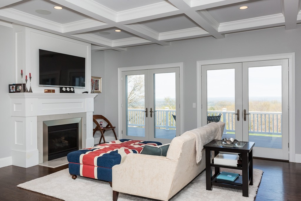 821 Ridge Road Wilbraham, MA 01095 - Photo 6 of 30 a living room with furniture a flat screen tv and a fireplace