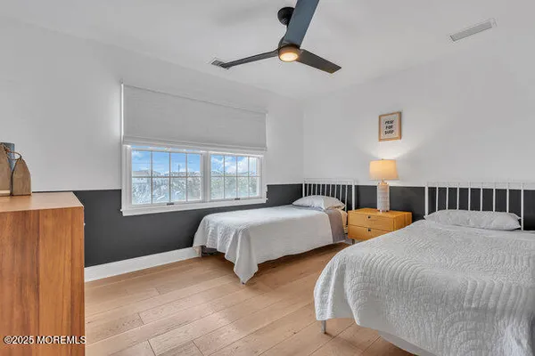 a bedroom with two beds and a window