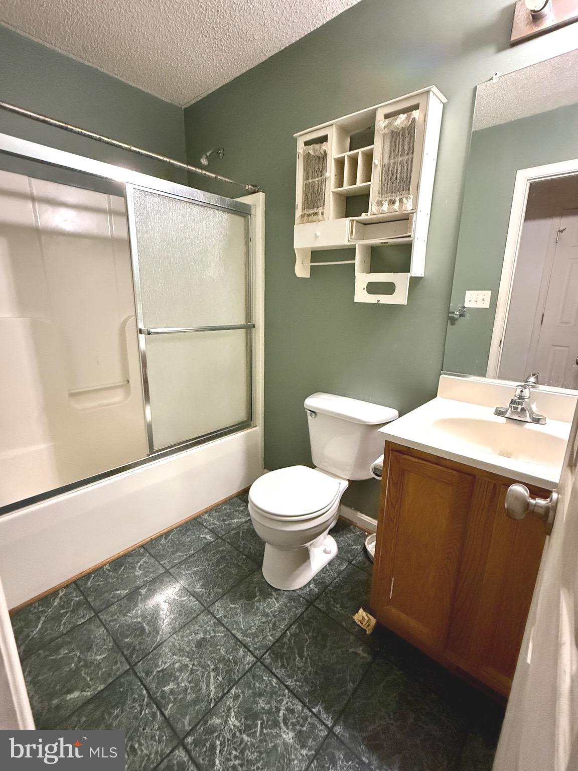 52 Morgan Street Inwood, WV 25428 - Photo 11 of 26 a bathroom with a toilet a sink and shower