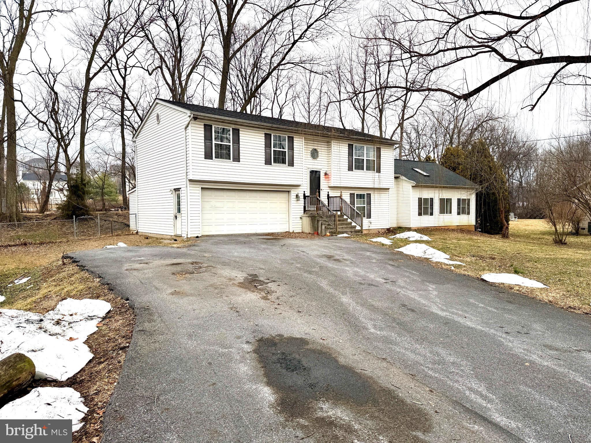 52 Morgan Street Inwood, WV 25428 - Photo 3 of 26 a front view of a house with a yard covered with snow