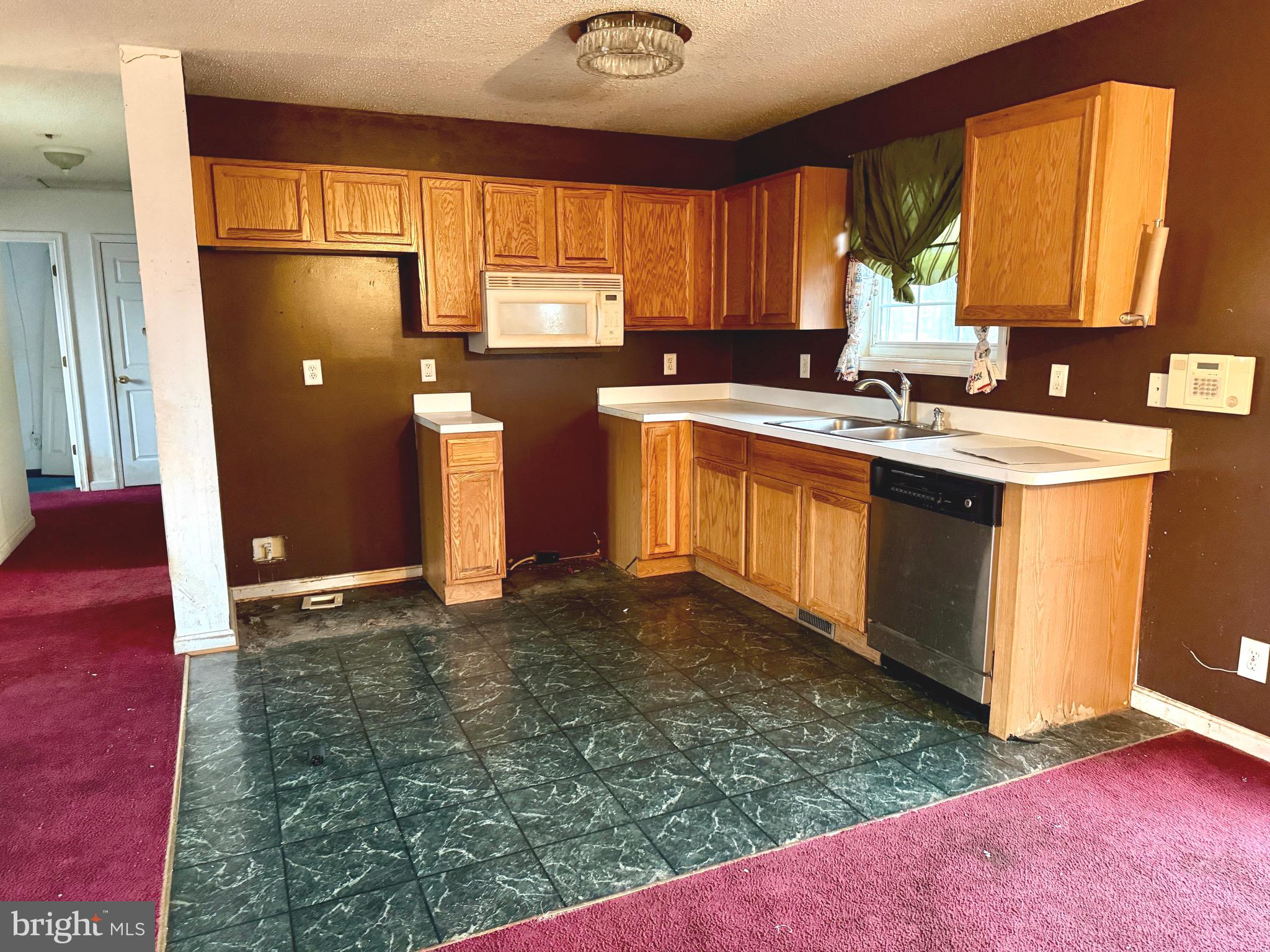 52 Morgan Street Inwood, WV 25428 - Photo 10 of 26 a kitchen with stainless steel appliances granite countertop a sink window and cabinets