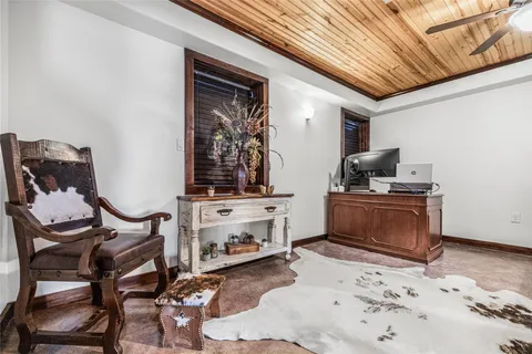 a living room with furniture and dresser